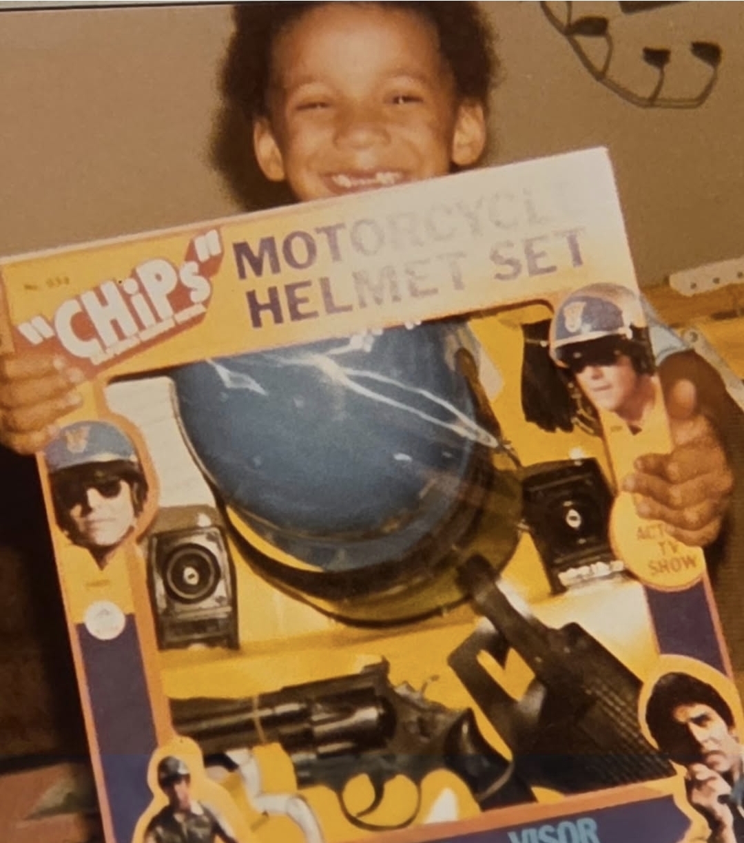 Childhood photo holding a CHiPs toy